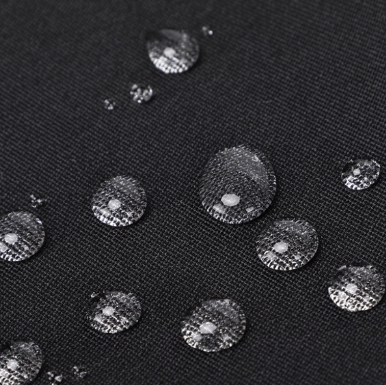 Water droplets on a black fabric surface